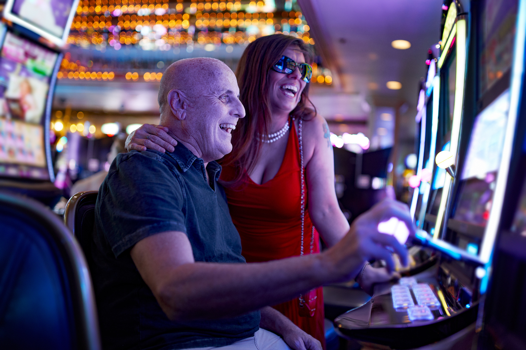 Elderly Couple Gambling on Slot Machine